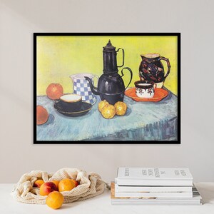 May include: A still life painting of a black teapot, a blue and white pitcher, a cup and saucer, and oranges on a blue tablecloth. The background is a yellow wall.