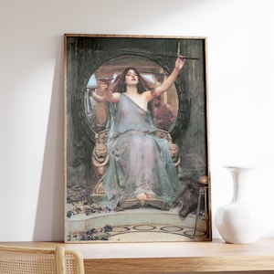 May include: A framed painting of a woman in a flowing white gown, sitting on a throne with a crown and holding a goblet. The background is a dark, circular room with a lion statue on each side of the throne.