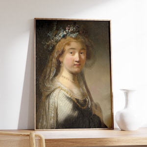 May include: A framed oil painting of a woman with a floral crown and a veil. She is wearing a white dress with a gold necklace and a dark blue shawl. The painting has a warm, earthy color palette.