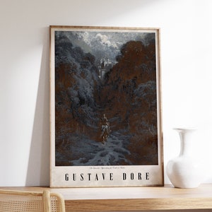 May include: Framed art print featuring a dark, detailed landscape illustration with a castle in the distance. The artwork, by Gustave Doré, depicts figures on a path through a forest. The print is in a wooden frame and is displayed on a wooden shelf.