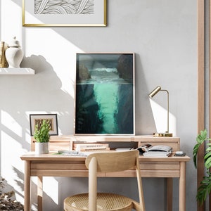 a desk with a chair and a painting on the wall