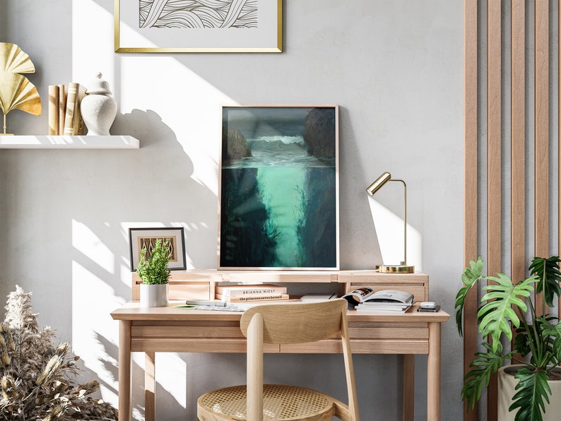 a desk with a chair and a painting on the wall