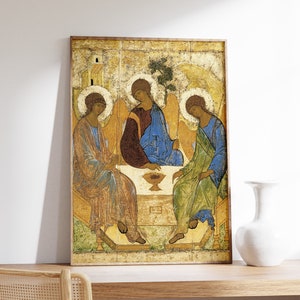 May include: A vintage-style religious icon depicting three figures in a golden frame. The figures are seated on a throne-like structure and are dressed in robes of blue, green, and brown. The icon has a faded, aged appearance, suggesting it is an antique.