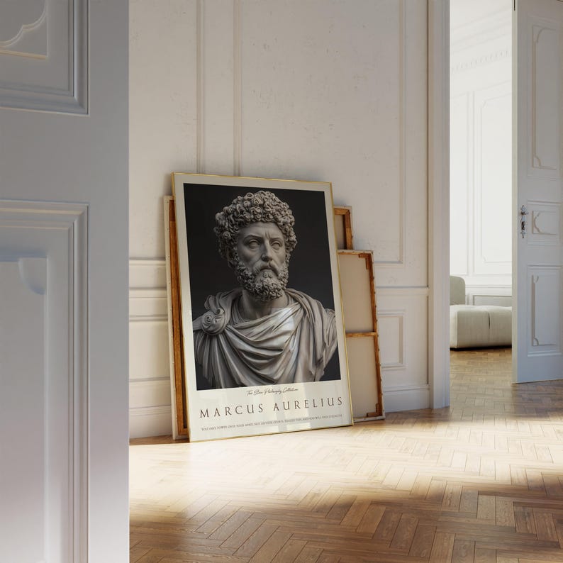 May include: A black and white poster with a gold frame featuring a bust of Marcus Aurelius, a Roman emperor and philosopher. The poster has the text "The Stoic Philosophy Collection" and "Marcus Aurelius" in a serif font.