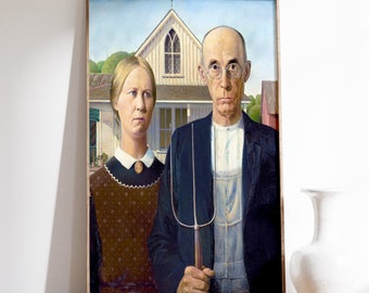 May include: A framed painting of a couple standing in front of a house. The man is wearing a dark suit and holding a pitchfork. The woman is wearing a brown dress with a white collar. The house is white with a brown roof and a small window.