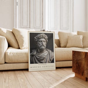 May include: A black and white poster featuring a bust of Marcus Aurelius, a Roman emperor and philosopher. The poster has a gold frame and the text "The Stoic Philosophy Collection MARCUS AURELIUS" at the bottom.