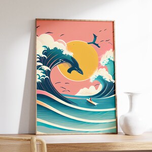 May include: A framed print of a stylized illustration of a large wave with a whale jumping out of the water. The background is a pink and yellow sunset with birds flying in the sky. A small boat is in the foreground.