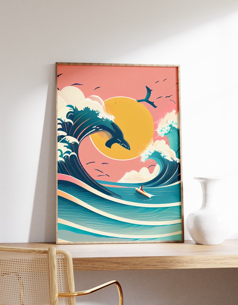 May include: A framed print of a stylized illustration of a large wave with a whale jumping out of the water. The background is a pink and yellow sunset with birds flying in the sky. A small boat is in the foreground.