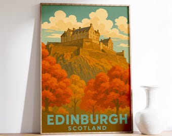 May include: A framed travel poster featuring Edinburgh Castle in Scotland. The artwork depicts the castle atop a hill, surrounded by orange and yellow trees, under a blue sky with fluffy clouds. The words "EDINBURGH SCOTLAND" are at the bottom.