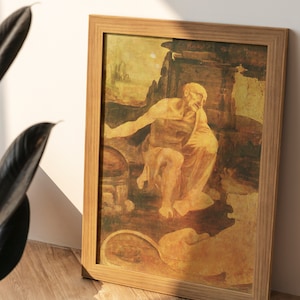 May include: A framed painting of a man sitting in a cave-like setting. The painting is done in a warm, earthy color palette with shades of brown, yellow, and orange. The man is wearing a robe and has a thoughtful expression on his face.