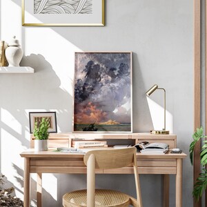 a desk with a chair and a painting on the wall
