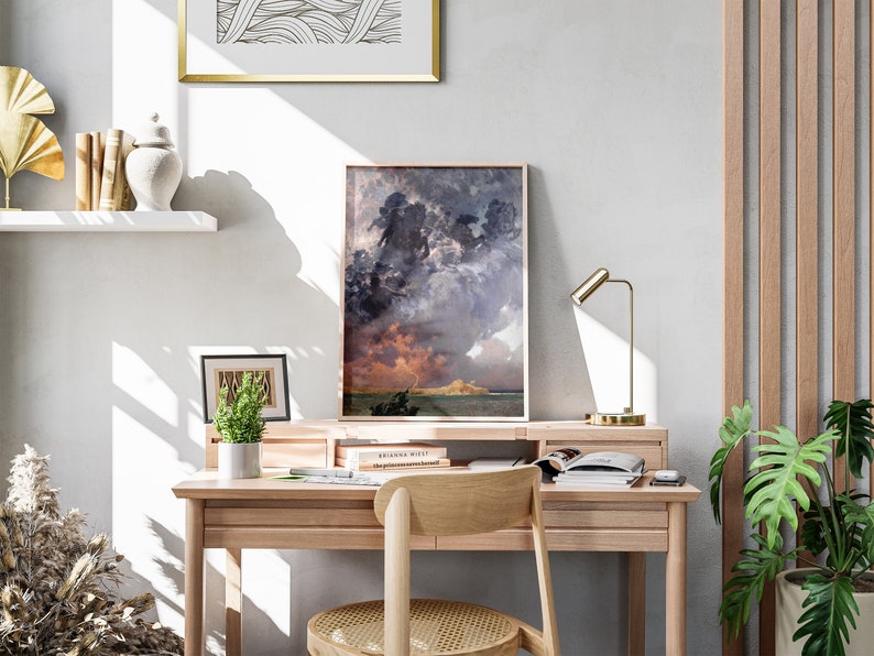a desk with a chair and a painting on the wall