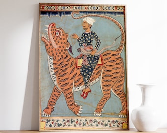 May include: A framed illustration of a man riding a tiger. The man is wearing a turban and a blue and gold robe. The tiger is orange and black with a blue background. The illustration is surrounded by a decorative border.