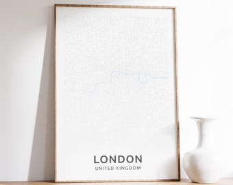 May include: A framed map print of London, United Kingdom, with a detailed street layout in white against a white background. The city name and country are printed in black. The frame is a light brown color.