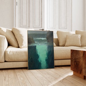 a living room with a couch and a painting on the floor