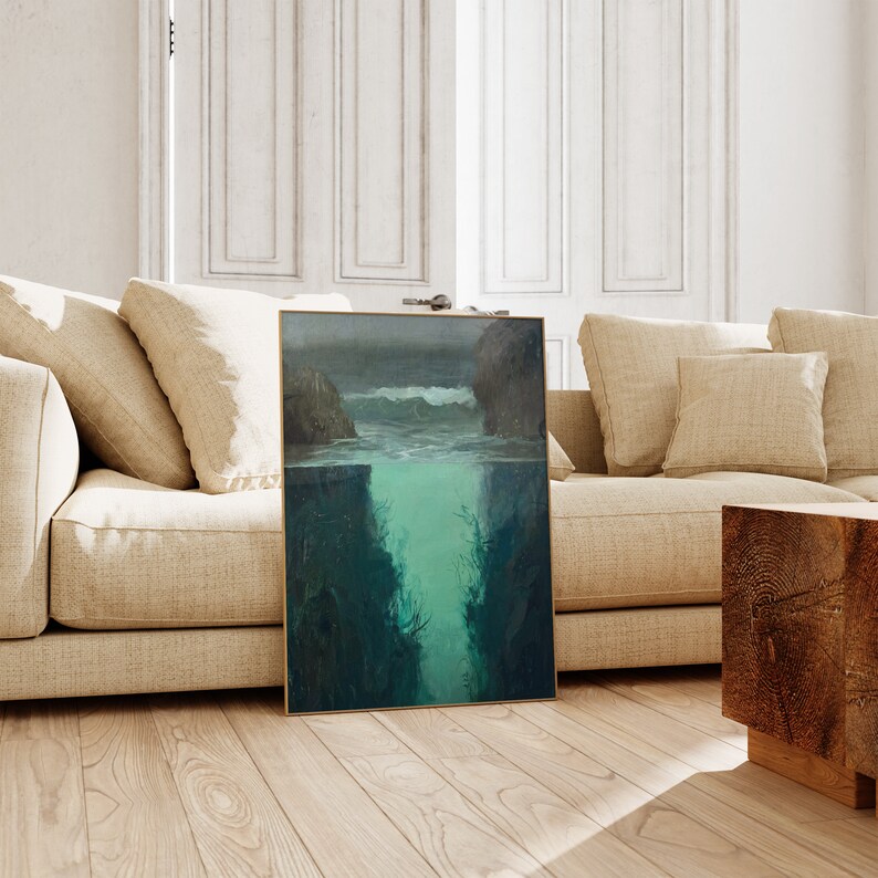 a living room with a couch and a painting on the floor