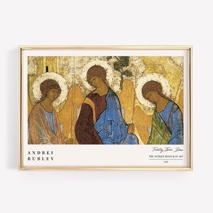 May include: A framed print of the "Trinity" icon by Andrei Rublev, a 15th-century Russian icon painter. The icon depicts three angels, each with wings and halos, seated together. The background is a warm, golden color.