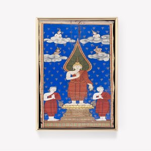 May include: A framed painting depicting a Buddhist deity in red robes standing on a lotus pedestal. The deity is surrounded by smaller figures in the clouds. The painting is on a blue background with a gold frame.