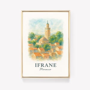 Könnte beinhalten: Gerahmter Aquarelldruck von Ifrane, Marokko, mit einem Minarett und Gebäuden mit orangefarbenen Dächern. Der Druck ist in einem goldfarbenen Rahmen. Der Text "IFRANE Morocco" befindet sich am unteren Rand des Bildes.