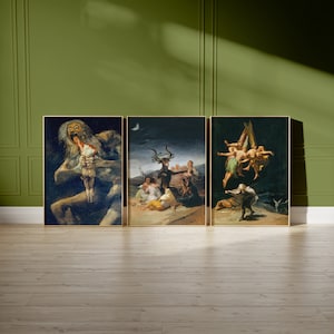 May include: Three framed paintings depicting scenes from the Spanish artist Goya's series "Los Caprichos". The first painting shows a monstrous figure devouring a child. The second painting shows a group of people gathered around a goat-like figure. The third painting shows a group of people flying through the air.