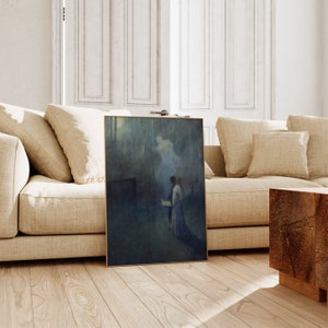 a living room with a couch and a painting on the floor