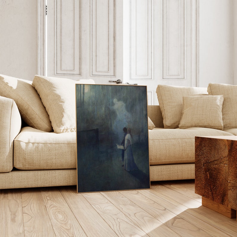 a living room with a couch and a painting on the floor