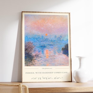 May include: A framed art print depicting a tranquil waterscape at sunset. The artwork includes the text "THE QURAN (94:6)" and "INDEED, WITH HARDSHIP COMES EASE." The colour scheme features blues, oranges, and pinks, evoking a sense of peace.