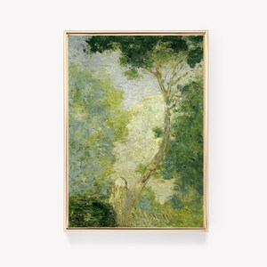 May include: A framed landscape painting with a gold border. The artwork depicts a lush forest scene with a prominent tree in the center. The color palette is dominated by shades of green and white, creating a serene and naturalistic feel.