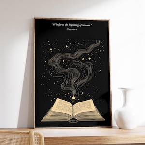 May include: A black and gold print with an open book with stars and a quote by Socrates that reads "Wonder is the beginning of wisdom."
