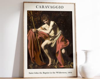 May include: Framed print of Caravaggio's "Saint John the Baptist in the Wilderness, 1604." The artwork shows a nude figure draped in red and white fabric, holding a staff. The title "CARAVAGGIO" is printed at the top of the frame.