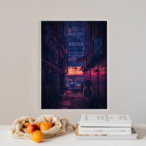May include: A digital art print of a narrow, rain-soaked alleyway in a city. The alley is lit by a warm, orange glow from a sign above a shop at the end of the alley. A blue bus is parked in the distance.