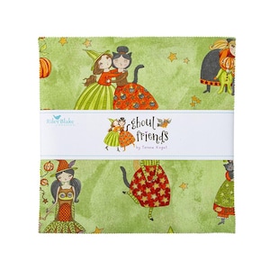 May include: A stack of fabric squares with a Halloween theme. The squares feature illustrations of witches, cats, and pumpkins on a green background with stars. The words "ghoul friends" are printed on a white band across the squares.
