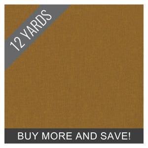 May include: A close-up of a textured, golden-brown fabric. The words "12 YARDS" are in white text on a gray diagonal banner. The phrase "BUY MORE AND SAVE!" is in white text on a gray banner at the bottom.