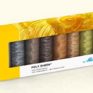May include: A box of 6 spools of Madeira Poly Sheen embroidery thread. The spools are arranged in a row and are labeled with the brand name "Madeira". The thread colors are gray, brown, dark brown, beige, light brown, and green.