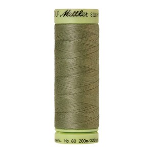 May include: A spool of olive green Mettler silk thread. The spool has a light green top and bottom with the brand name and thread details printed on it. The thread is mercerized, No. 60, and contains 200m/220yd of thread.