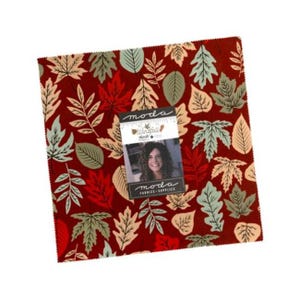 May include: A square fabric bundle featuring a deep red background with a repeating pattern of autumn leaves in shades of cream, sage green, and orange. A paper label is attached to the center with the text moda Windfall and moda FABRICS+SUPPLIES.