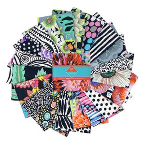 May include: A collection of 18 black and white fabric squares with various patterns, including polka dots, stripes, and abstract designs. The fabric squares are arranged in a fan shape, with the center square featuring a bright floral design.