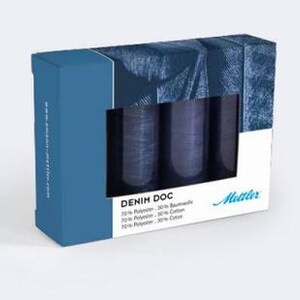 May include: A box set of denim-colored thread spools. The box is blue and white with the text "DENIM DOC" and "Metter" printed on it. The thread spools are visible through a rectangular window.