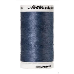May include: A spool of blue polyester thread with the brand name "Mettler" and the text "poly sheen" printed on the label. The spool is labeled "German Made".