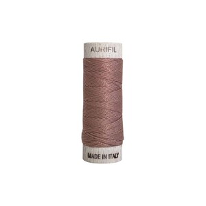 May include: A spool of Aurifil thread in a muted rose color. The thread is tightly wound around a wooden core. The top of the spool has the word "AURIFIL" printed on it, and the bottom reads "MADE IN ITALY".