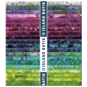 May include: A stack of fabric strips featuring a gradient of colors from white and gray to purple, pink, blue, and green with batik patterns. A vertical blue band runs down the center with the white text ISLAND BATIK and a lizard logo.