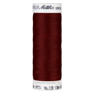 May include: A spool of maroon thread with the text "GROUP Gütermann SERRFLEX" on the label. The spool is labeled "No. 128 130m/142yd (PTT)".