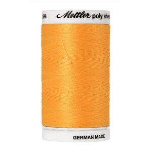 May include: A spool of orange thread with the brand name "Metzler" and the text "poly sheen" on the label. The label also says "German Made".