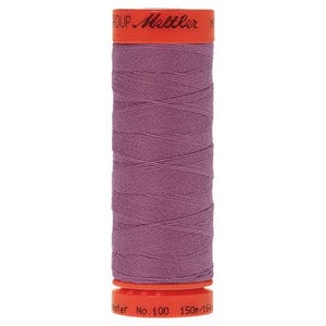 May include: A spool of purple thread with a bright orange label that reads "Mettler Group No. 100 150m/164yd Polyester".