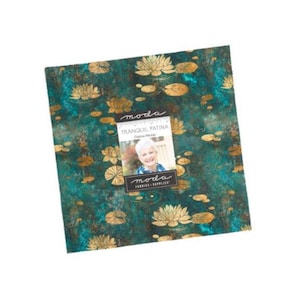 May include: A square fabric stack featuring a teal and dark green mottled background with gold lotus flowers and lily pads. A central label displays the text moda, TRANQUIL PATINA, Debbie Maddy, and moda FABRICS + SUPPLIES with a photo of a person.