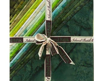 May include: A stack of square fabric pieces featuring a gradient of green shades from light lime to deep forest green. The fabric has a mottled batik texture and is tied together with a branded ribbon printed with the text Island Batik.