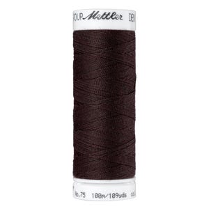 May include: A spool of dark brown thread with the text "Mettler" and "100m/109yds" printed on the label.