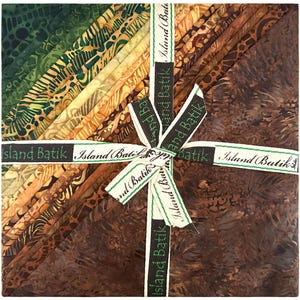 May include: A stack of batik fabric squares in shades of green, gold, and brown, tied with a ribbon that reads "Island Batik." The fabric has various patterns and textures, creating a visually rich display. The ribbon is white with green and black text.