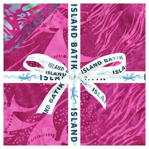 May include: A stack of square fabric pieces featuring various shades of magenta and pink with batik patterns. The fabric is tied with a white ribbon printed with the text ISLAND BATIK and blue lizard icons, crossing in the center of the stack.