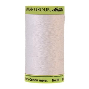 May include: A white spool of 100% cotton mercerized thread with a green label that reads "AMANN GROUP Mettler" and "100% Cotton merc. No.60 800m".
